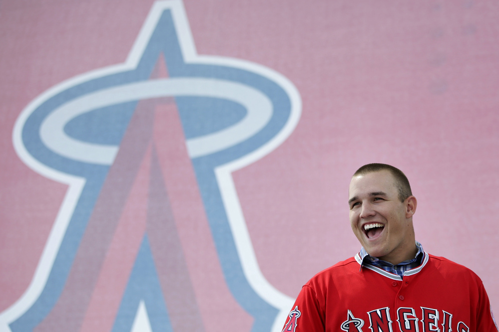 RICH MAN: Los Angeles Angels outfielder Mike Trout laughs during a media gathering held Saturday to announce his six-year contract extension with the Angels at Angel Stadium in Anaheim, Calif. Trout and the Angels agreed Friday night to a $144.5 million, six-year contract, keeping the young star under club control through 2020.