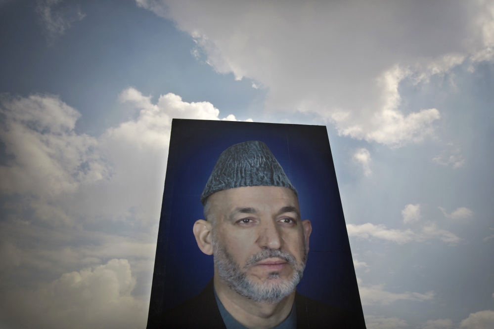 The Associated Press In this Saturday, March 29, 2014 photo, a giant picture of Afghan President Hamid Karzai is displayed on the parade ground of the Ministry of Defense in Kabul, Afghanistan.