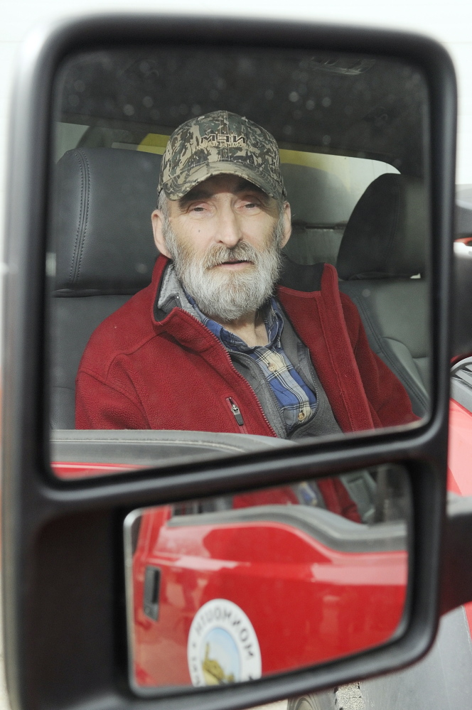 GRATEFUL: Leonard Crocker, sitting in a Monmouth Public Works truck on Friday at the town garage, said he would like to find the woman who apparently helped save his life March 17 in Monmouth after he had a heart attack and collapsed on a road while working.