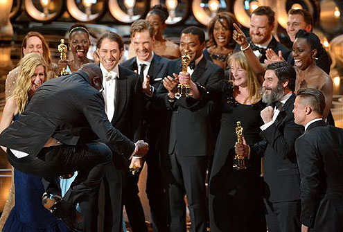 Director Steve McQueen, left, celebrates with the cast and crew of "12 Years a Slave" as they accept the award for best picture during the Oscars at the Dolby Theatre in Los Angeles on Sunday.
