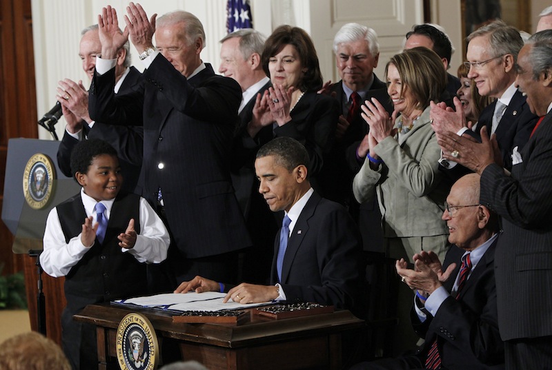 In this March 2010, file photo President Barack Obama is applauded after signing the Affordable Care Act into law in the East Room of the White House in Washington. The Obama administration announced Wednesday that some Americans with health insurance policies that don’t meet consumer standards set by the Affordable Care Act will be allowed to keep their plans into 2017.