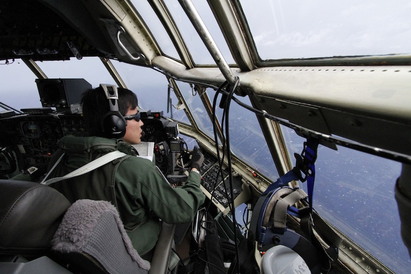 Japanese Air Self-Defense Force copilot Ryutaro Hamahira scans the ocean aboard a C-130 aircraft while it flies over the search area in the southeastern Indian Ocean on Friday.