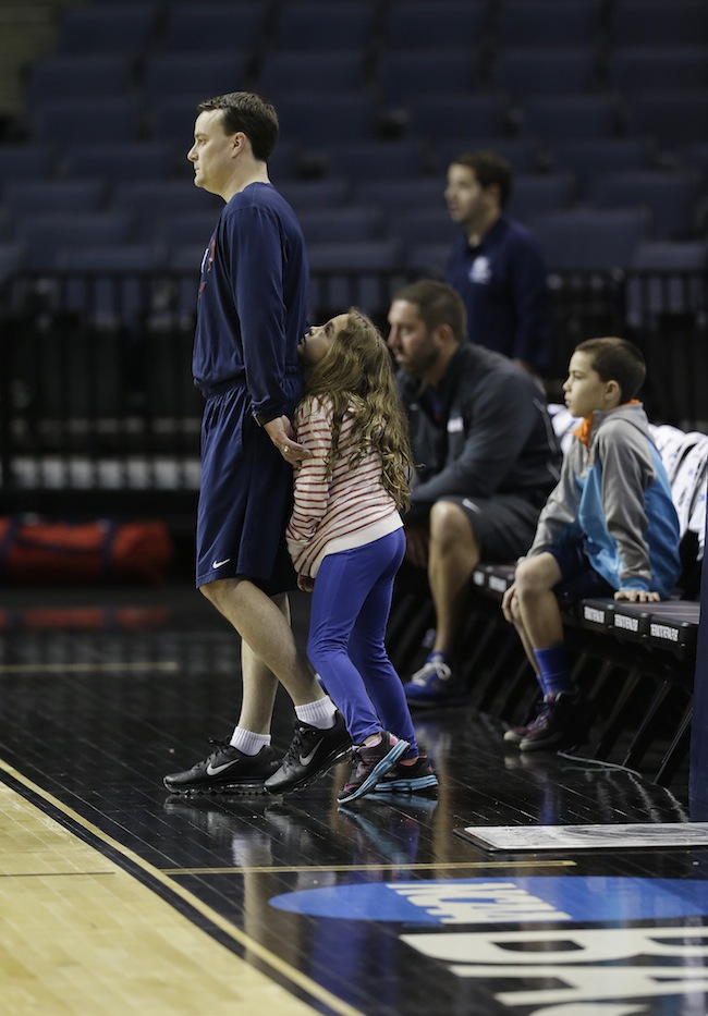 Dayton head coach Archie Miller watches practice with his daughter Leah Grace during practice at the NCAA college basketball tournament, Wednesday, March 26, 2014, in Memphis, Tenn. Dayton plays Stanford in a regional semifinal on Thursday. March Madness