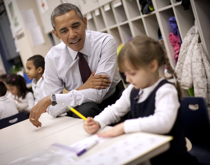 President Barack Obama sits with Emily Hare as she completes her spelling lessons during his visit to a preschool classroom at Powell Elementary School in the Petworth neighborhood of Washington, Tuesday, March 4, 2014. Obama visited the school to talk about his 2015 budget proposal, which was released today. Powell elementary has seen rapid growth in recent years and serves a predominantly Hispanic student body. Washington DC Mayor Vincent Gray, who greeted Obama at the school, recently directed $20 million to Powell for a planned modernization and addition.