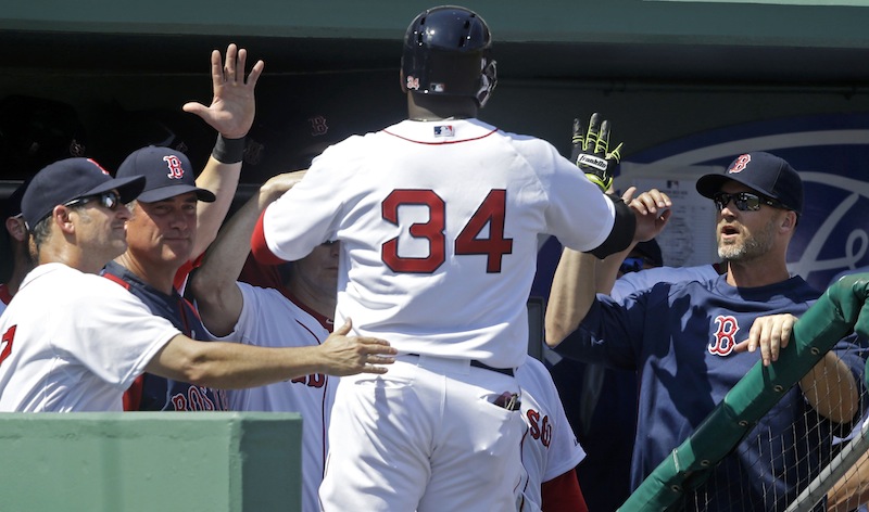 Boston Red Sox designated hitter David Ortiz (34) is greeted at the dugout after a solo homer in the third inning of an exhibition baseball game against the Tampa Bay Rays in Fort Myers, Fla., on Monday.