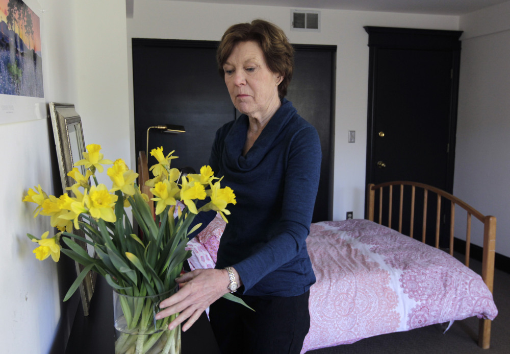 Lorraine Rorke Bader arranges fresh flowers recently at her San Francisco home before an overnight guest arrives. Bader rents out the room, with a three-night minimum stay, for $120 a day using the Airbnb online home rental service.