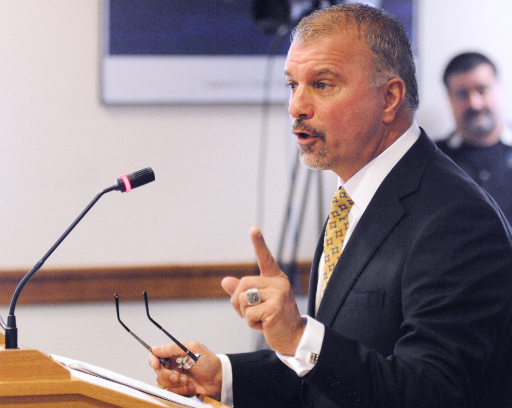 Claims unfairness: Kevin Cormier, vice president of Funtown Splashtown USA in Saco, testifies Tuesday against a bill that would remove some highway signs, in Augusta. Cormier said Funtown would lose its sign while ski areas would keep theirs.