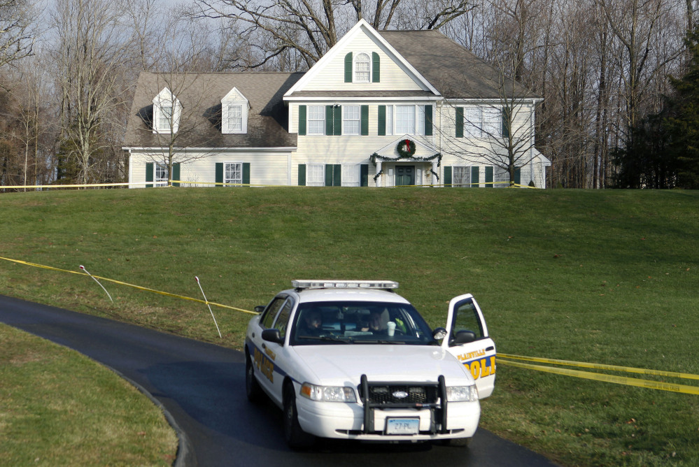 Crime scene tape surrounds the former home of Nancy Lanza, who was killed there by her son Adam Lanza before he forced his way into Sandy Hook Elementary School on Dec. 14, 2012, and killed 26 children and adults. Some Newtown residents say they want the home torn down and the property turned into a park or nature preserve.
