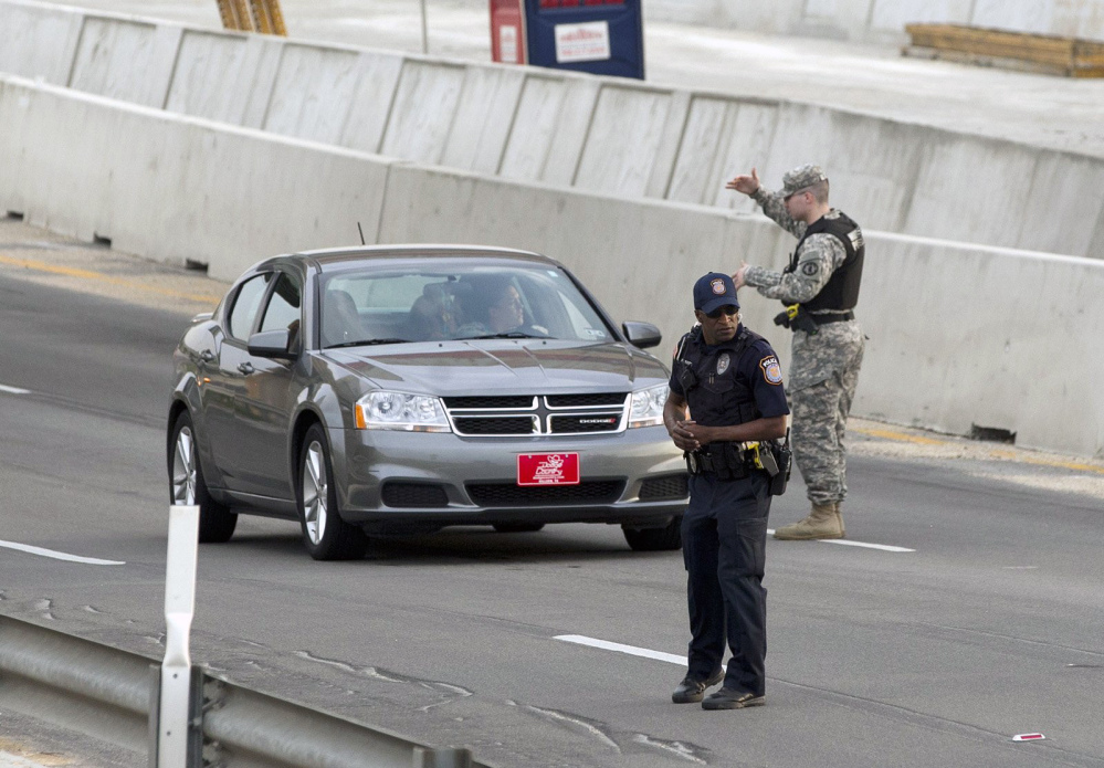 Vehicles are checked outside of the Bernie Beck Gate, Wednesday, April 2, 2014, in Fort Hood, Texas. One person was killed and 14 injured in a shooting at Fort Hood, and officials at the base said the shooter is believed to be dead.