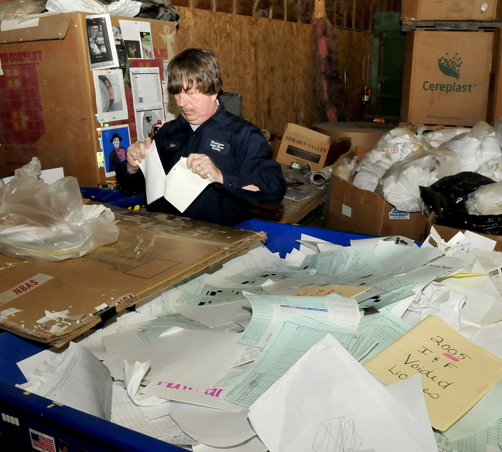 MORE BIZ: Skowhegan Recycling Center employee Clyde Merrill sorts high grade office paper at the center on Thursday. The center will soon receive more materials from the town of Cornville.