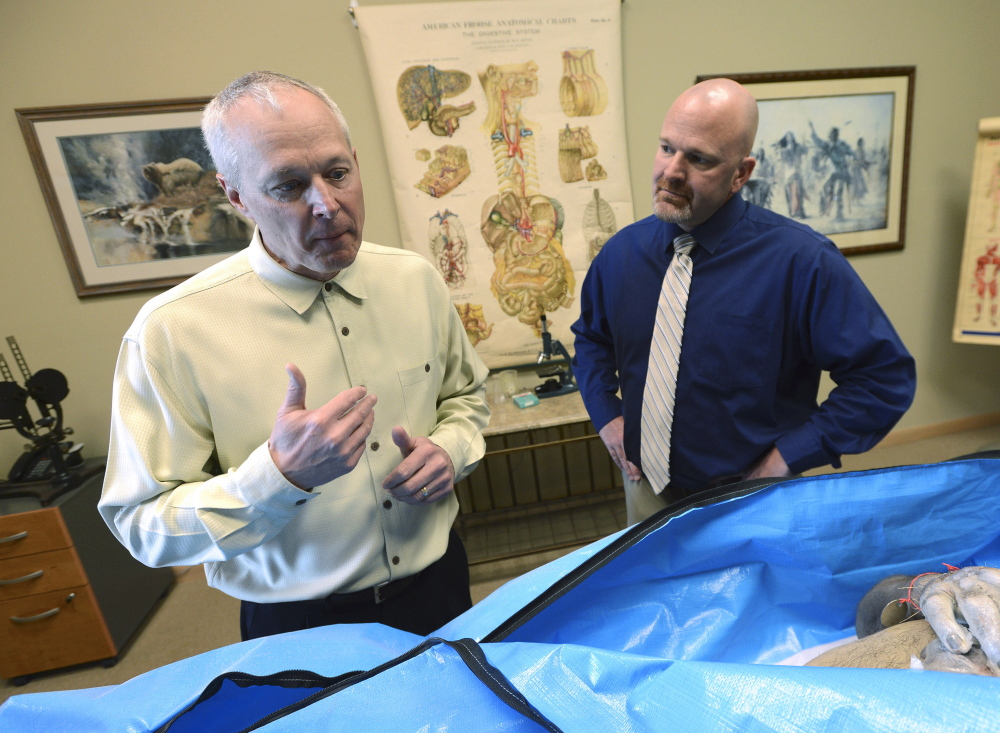 Dr. Tom Pliura, left, head of the McLean County Medical Society, hopes to begin after-school cadaver dissection labs on April 10. At right is Gary R. Tipsord, superintendent for the LeRoy Community Unit School District.