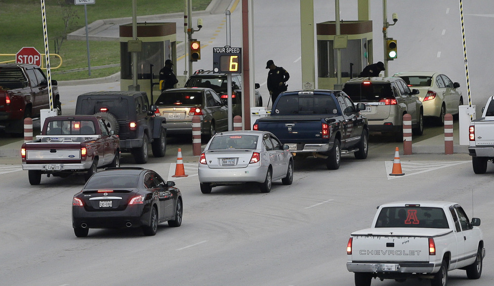Security check vehicles as they enter Fort Hood’s main gate, Thursday, April 3, 2014, in Fort Hood, Texas. A soldier opened fire Wednesday on fellow service members at the Fort Hood military base, killing three people and wounding 16 before committing suicide.