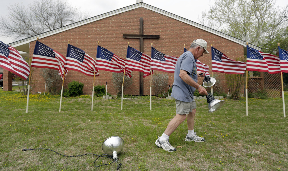 Bob Gordon works on a memorial for the victims of Wednesday’s shooting at Fort Hood, Thursday, April 3, 2014, at Central Christian Church in Killeen, Texas. A soldier opened fire Wednesday on fellow service members at the Fort Hood military base, killing three people and wounding 16 before committing suicide.