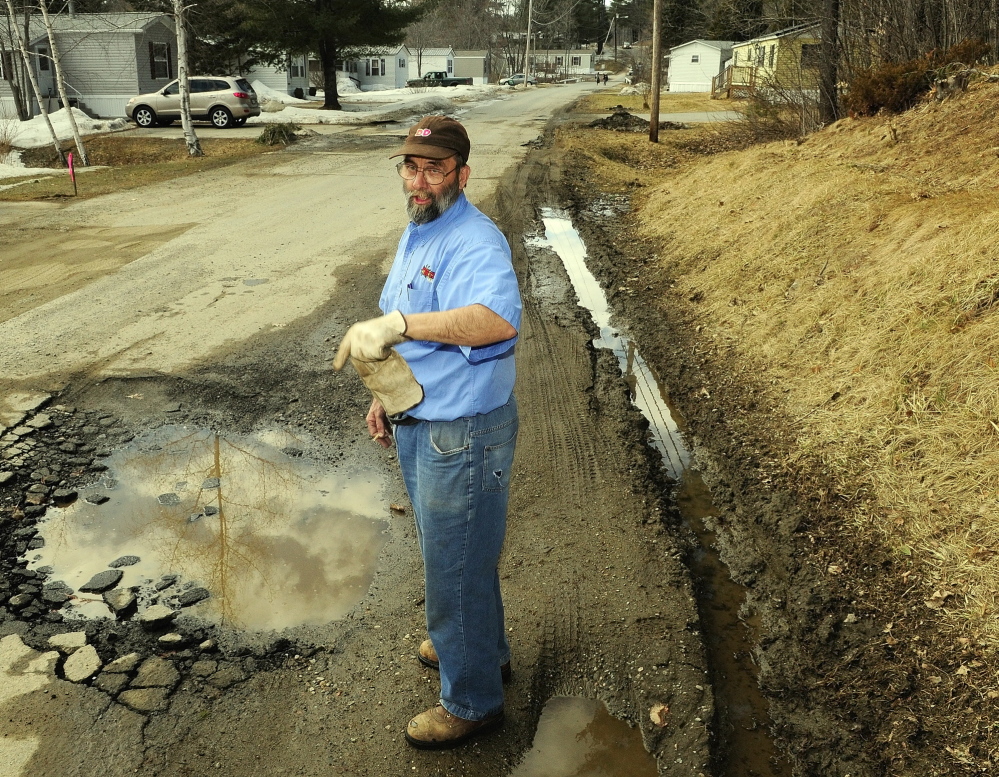 BAD ROADS: Bill Marson talks about the rough condition of Sparrow Drive in the Riverside Drive Village on Thursday in Augusta.
