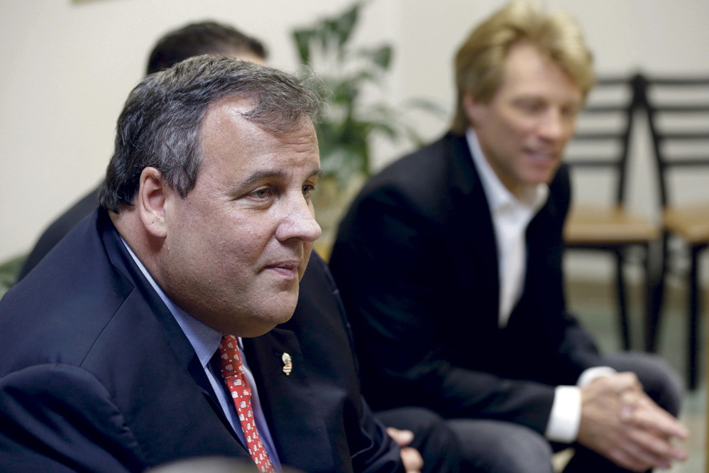 SAVING LIVES: New Jersey Gov. Chris Christie, left, sits with singer Jon Bon Jovi, right, while visiting patients at the Turning Point drug rehab program at Barnert Medical Arts Complex in Paterson, N.J., on May 2, 2013.