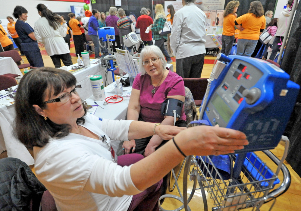 Off-the-cuff care: Vicki Goodwin, left, a registered nurse at Inland Hospital, checks the blood pressure of Connie Finley on Saturday at the 17th annual World of Women’s Wellness, sponsored by Inland Hospital at Thomas College.