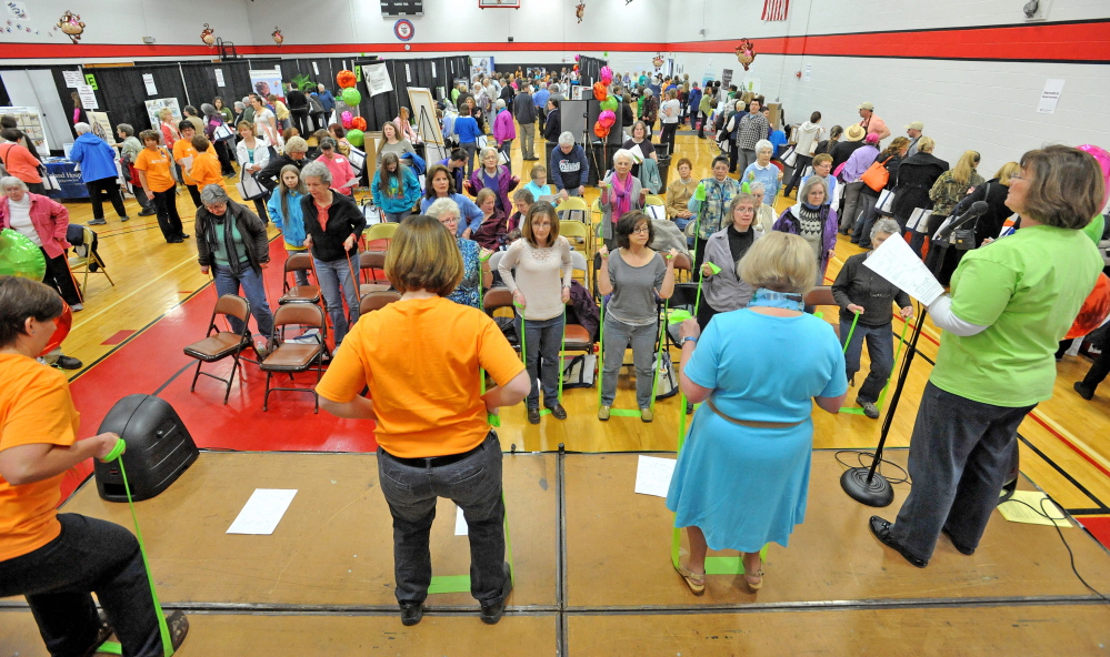 That’s a stretch: Women watch and participate in a free elastic band exercise demonstration Saturday at the 17th annual World of Women’s Wellness, sponsored by Inland Hospital at Thomas College.