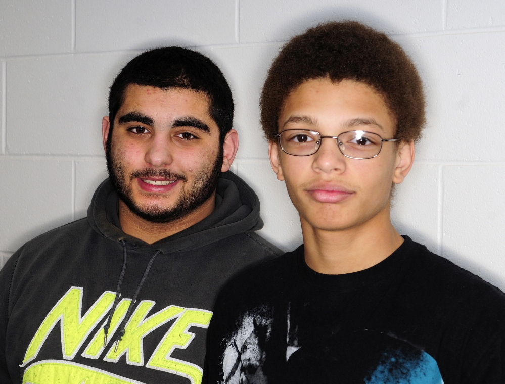Pay it forward: Cony wrestlers Elais Younes, left, and Tre Caudill take the statement “Do something nice for somebody,” seriously.