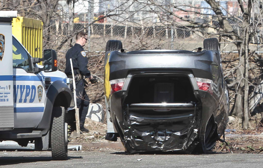 Police recover a 2009 Honda Accord from the Steinway Creek on Saturday in New York. The driver drove the car off a dead-end street in a desolate industrial area. The car flipped over a wooden curb into the East River inlet, killing four passengers.