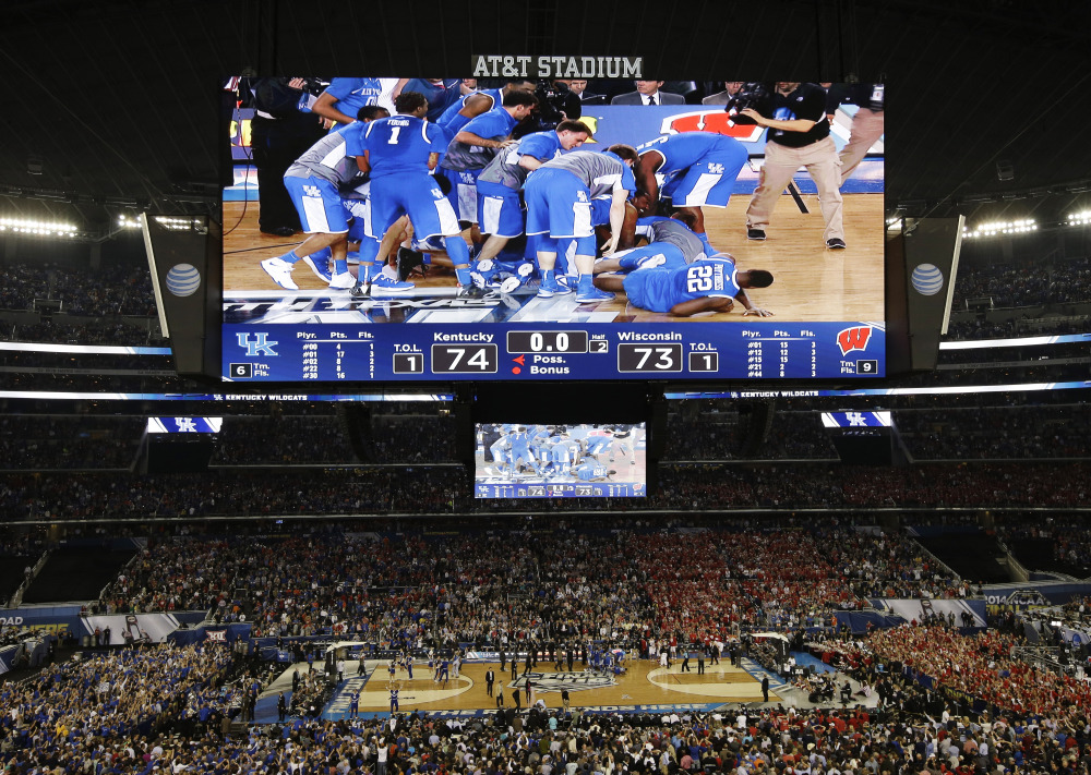 Kentucky celebrates after guard Aaron Harrison made a three-point basket in the final seconds against Wisconsin to win the game 74-73 during their NCAA Final Four semifinal game Saturday.
