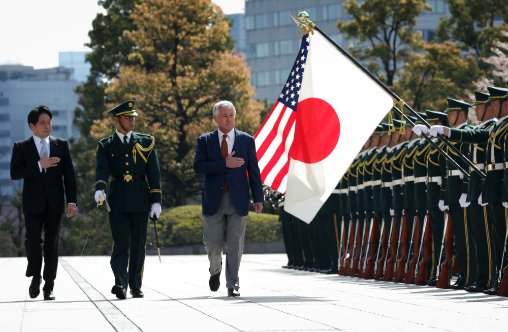U.S. Secretary of Defense Chuck Hagel, right, accompanied by Japanese Defense Minister Itsunori Onodera, left, reviews honor guards at the Japanese Ministry of Defense headquarters Sunday.