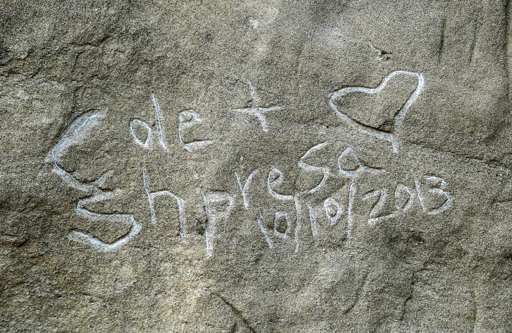 Graffiti spelling “Cole & Shpresa 10/10/2013” is seen carved into the Pompeys Pillar National Monument in Montana.