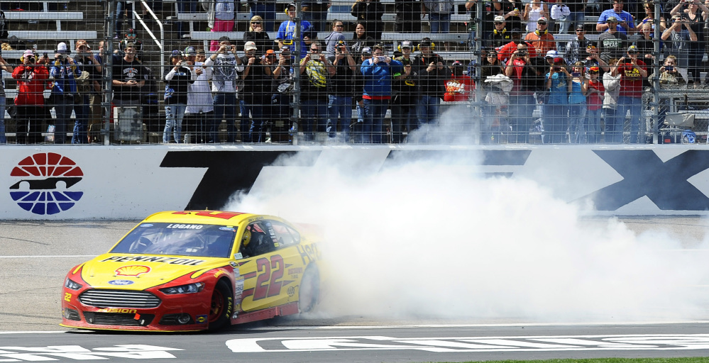 NICE WIN: Joey Logano burns his tires after winning the Duck Commander 500 on Monday at Texas Motor Speedway in Fort Worth, Texas.
