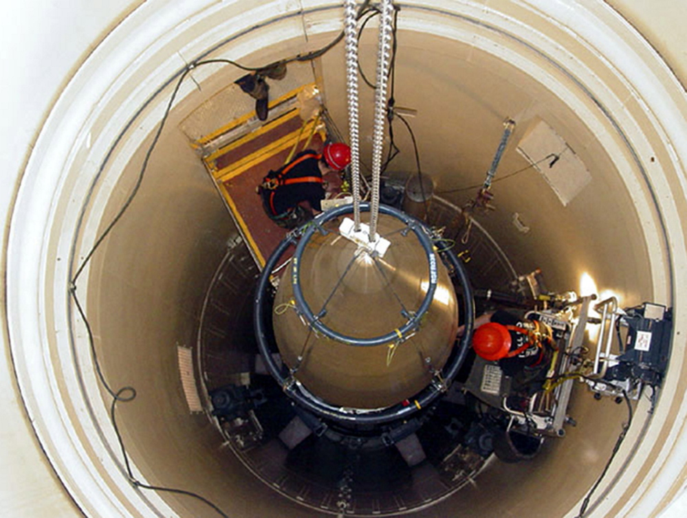 In this image released by the U.S. Air Force, an Air Force Base missile maintenance team removes the upper section of an ICBM at a Montana missile site. The U.S. will keep its current force of 450 land-based nuclear missiles but remove 50 from their launch silos as part of a plan to bring the U.S. into compliance with a 2011 U.S.-Russia arms control treaty.