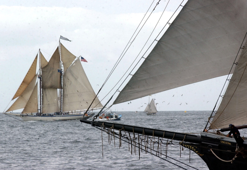 The schooner Spirit of Massachusetts, left, races at an annual Gloucester Schooner Festival off the coast of Gloucester, Mass. It is one of three traditional schooners owned by Ocean Classroom Foundation, based in Portland.