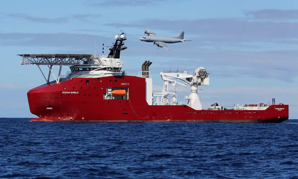 In this photo provided by the Australian Defense Force, a Royal Australian Air Force AP-3C Orion flies past Australian Defense vessel Ocean Shield Wednesday on a mission to drop sonar buoys to assist in the acoustic search of the missing Malaysia Airlines Flight 370 in the southern Indian Ocean.