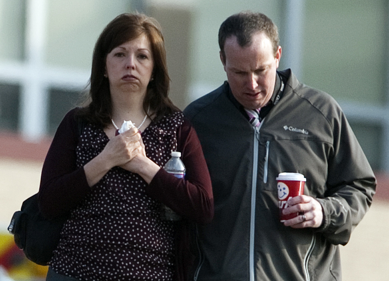 A man and woman walk away from Franklin Regional High School after more then a dozen students were stabbed by a knife wielding suspect at the school on Wednesday, April 9, 2014, in Murrysville, Pa., near Pittsburgh. The suspect, a male student, was taken into custody and is being questioned.