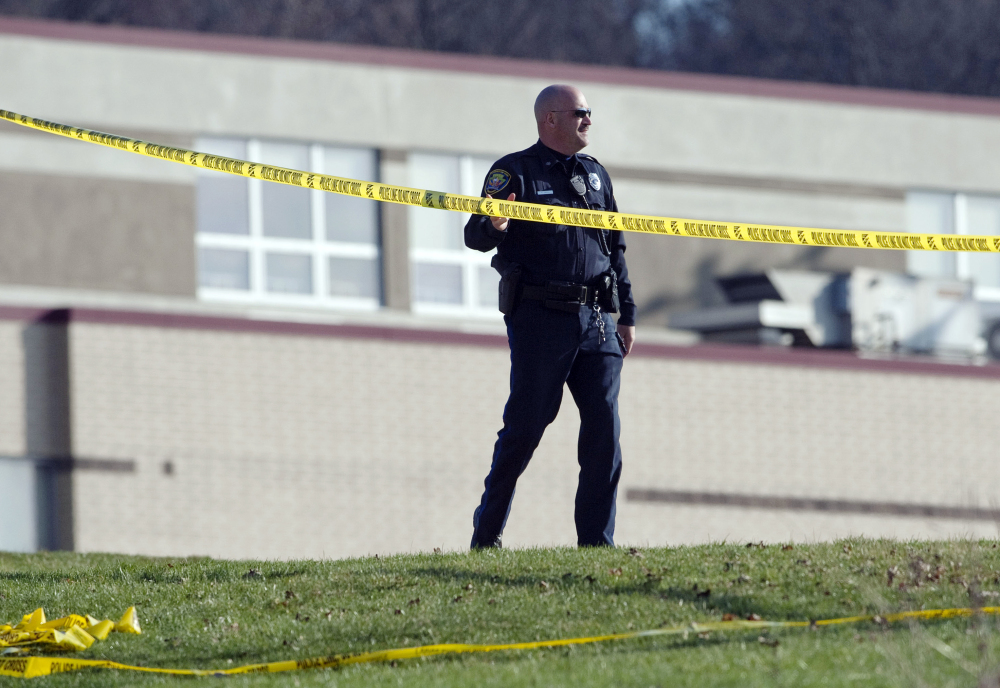 A police officer stands by the scene outside Franklin Regional High School where more then a dozen students were stabbed by a knife wielding suspect on Wednesday, April 9, 2014, in Murrysville, Pa., near Pittsburgh. The suspect, a male student, was taken into custody and is being questioned.