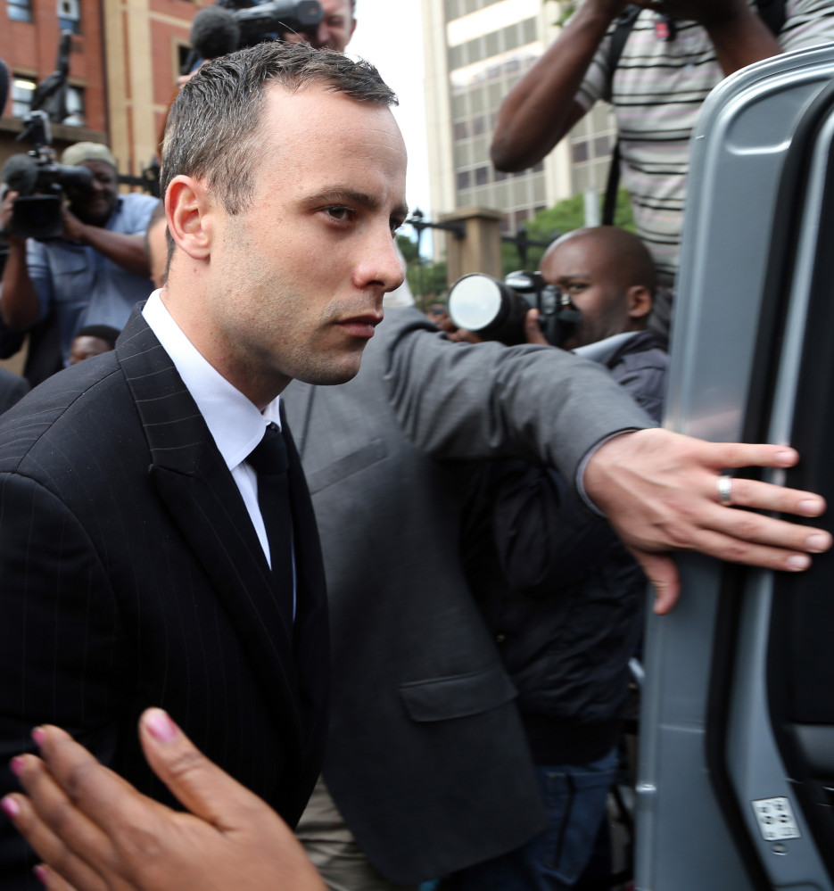Oscar Pistorius leaves the high court in Pretoria, South Africa, Wednesday. He faces a possible prison term of 25 years to life if convicted of premeditated murder.