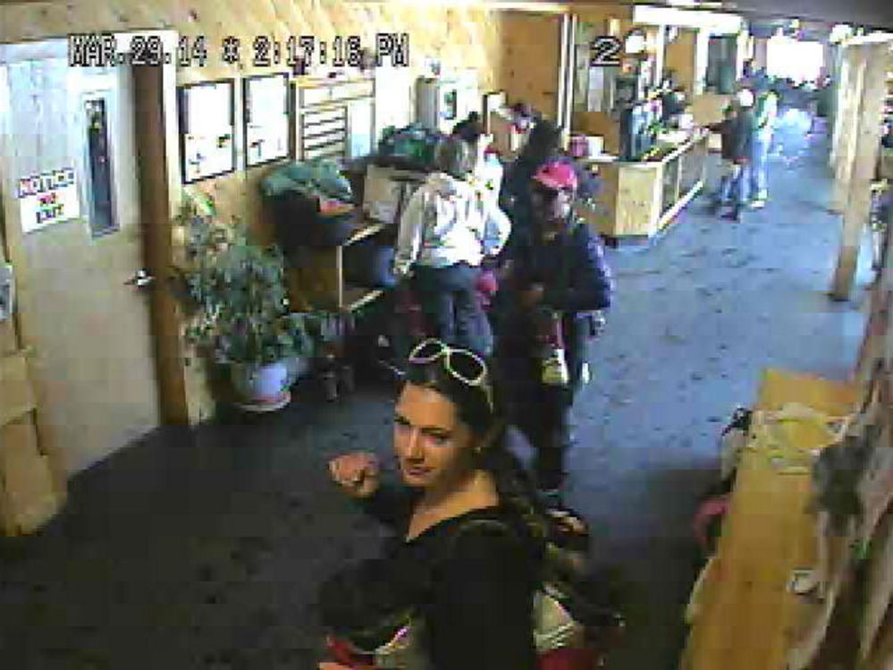 SUSPECT: The Franklin County Sheriff’s Department released this photo showing a woman in the foreground who is suspected of stealing a backpack from Saddleback Mountain in Rangeley.