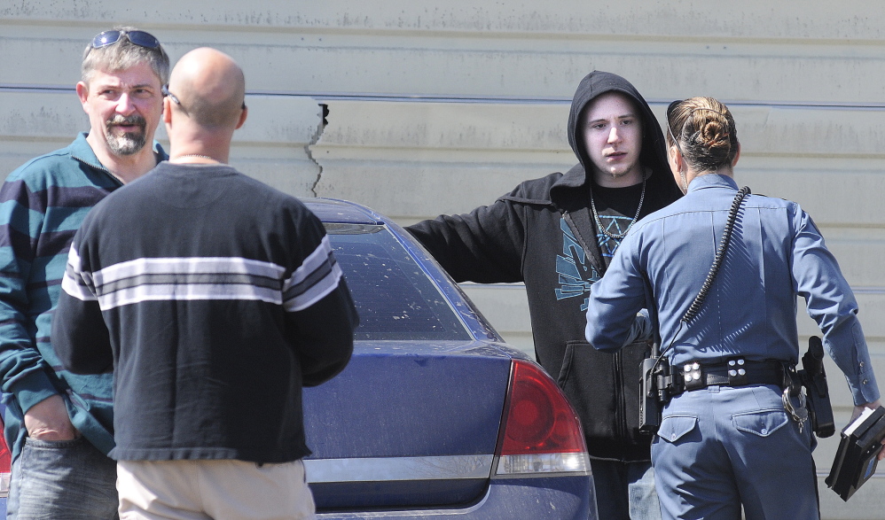 Questioning: Frederick Horne Sr., left, and Frederick Horne Jr. speak with Maine State Police officers on Thursday after being summoned on a charge of sex trafficking at their Sidney residence.