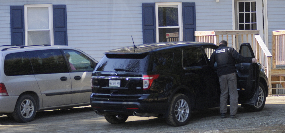 Evidence: Investigators collect evidence Thursday at a mobile home in Litchfield. Police summoned Gretchen Patrick, 51, of Augusta, on a charge of sex trafficking, saying she operated Sarah’s Place, an escort service.