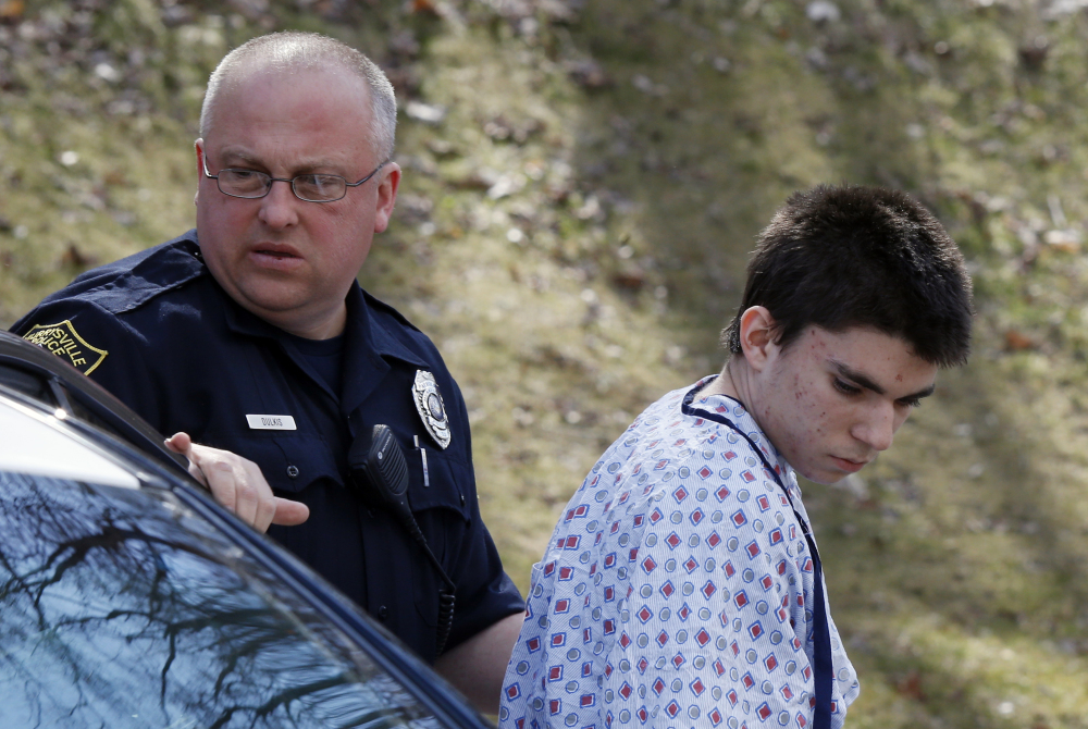 Alex Hribal, the suspect in the multiple stabbings at the Franklin Regional High School in Murrysville, Pa., is escorted by police to a district magistrate to be arraigned on Wednesday.