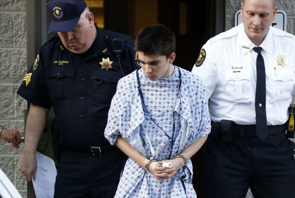 Alex Hribal, the suspect in the stabbings at the Franklin Regional High School near Pittsburgh, is taken from a district magistrate after he was arraigned on charges in the attack on Wednesday in Export, Pa.