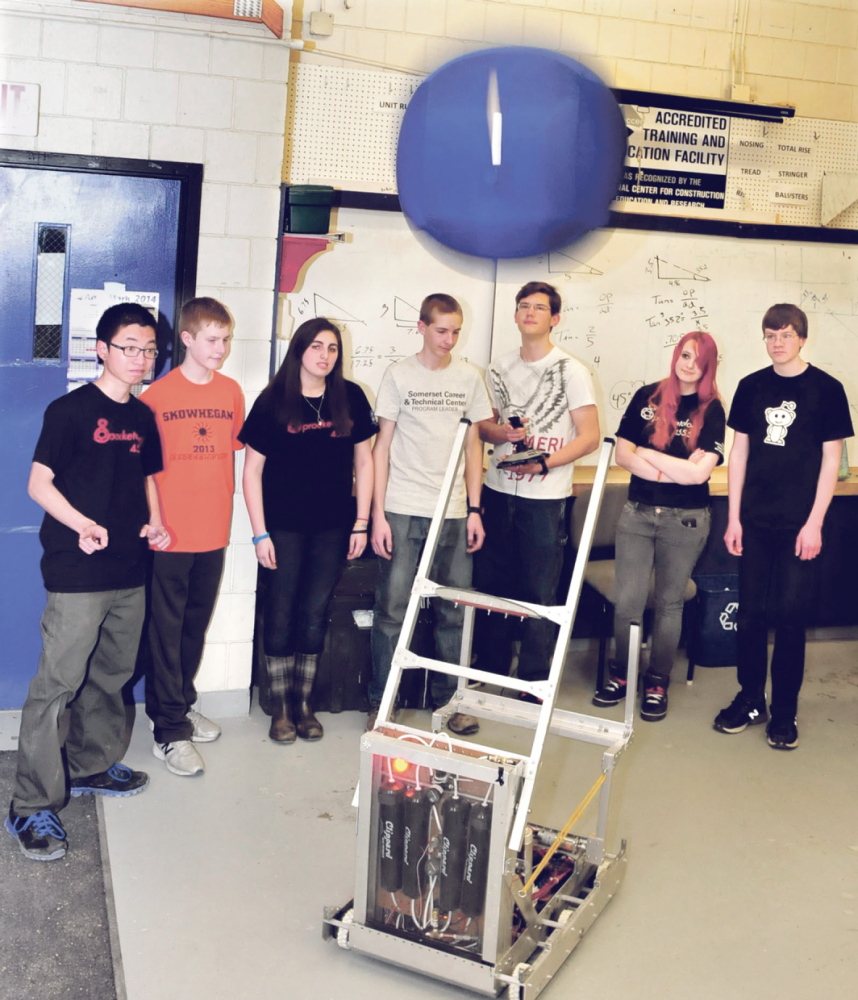 CATCH: Members of the Skowhegan Area High School Sprocketology team demonstrate how the robot the built named Spock can throw a ball.