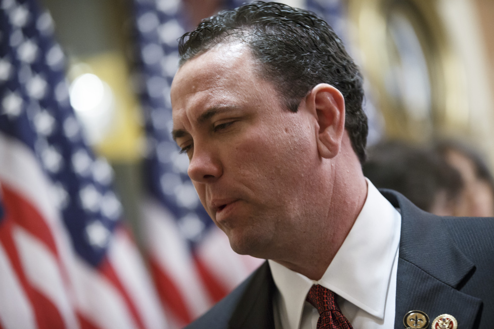 This photo taken Nov. 21, 2013 shows then-newly-elected Rep. Vance McAllister, R-La. waiting to be sworn in on Capitol Hill in Washington. McAllister says he's asking his family and constituents for forgiveness after a West Monroe newspaper published a video that it says shows the congressman kissing a female staffer in his congressional office in Monroe, La. McAllister, only in office a little over four months, attracted national attention because of his endorsement from the bearded men of the "Duck Dynasty" reality TV show. (AP Photo/J. Scott Applewhite)