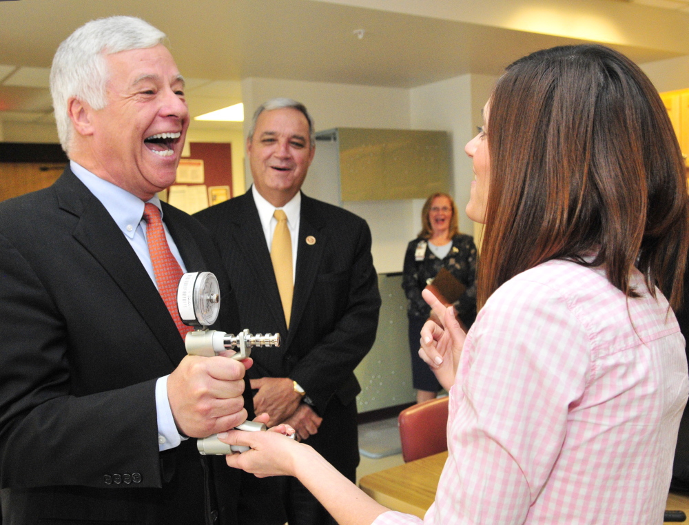 Rep. Mike Michaud, D-2nd District, left, laughs with occupational therapist Heidi Kelly, as she shows him a grip strength tester during a tour of the VA Maine Healthcare Systems-Togus on Friday. Michaud was joined on the tour by the chairman of the House Veterans’ Affairs Committee Rep. Jeff Miller, R-Fla., center.