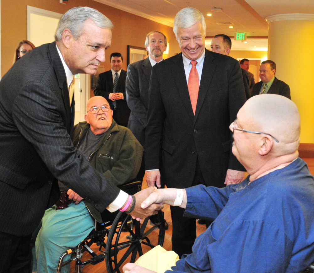 The chairman of the House Veterans’ Affairs Committee Rep. Jeff Miller, R-Fla., left, shakes hands with Bruce Pray, of Winthrop, during a tour of the VA Maine Healthcare Systems-Togus on Friday. Pray and Donal Durgin, second from left, also of Winthrop, were chatting when Miller and Rep. Mike Michaud, D-2nd District, second from right, passed through.