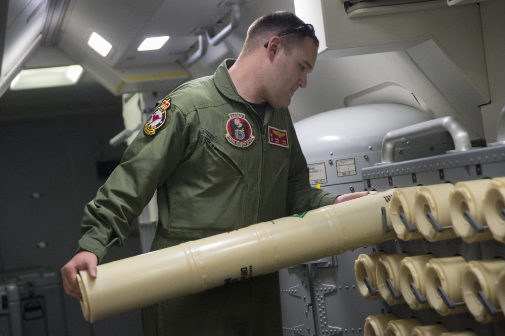 The Associated Press/U.S. Navy Airman 2nd Class Karl Shinn unloads a sonobuoy from a rack onboard a P-8A Poseidon aircraft during a search mission looking for missing Malaysia Airlines flight MH370 over the southern Indian Ocean, in a photo released Thursday. Sonobuoys are used to detect frequencies and signals in the water.