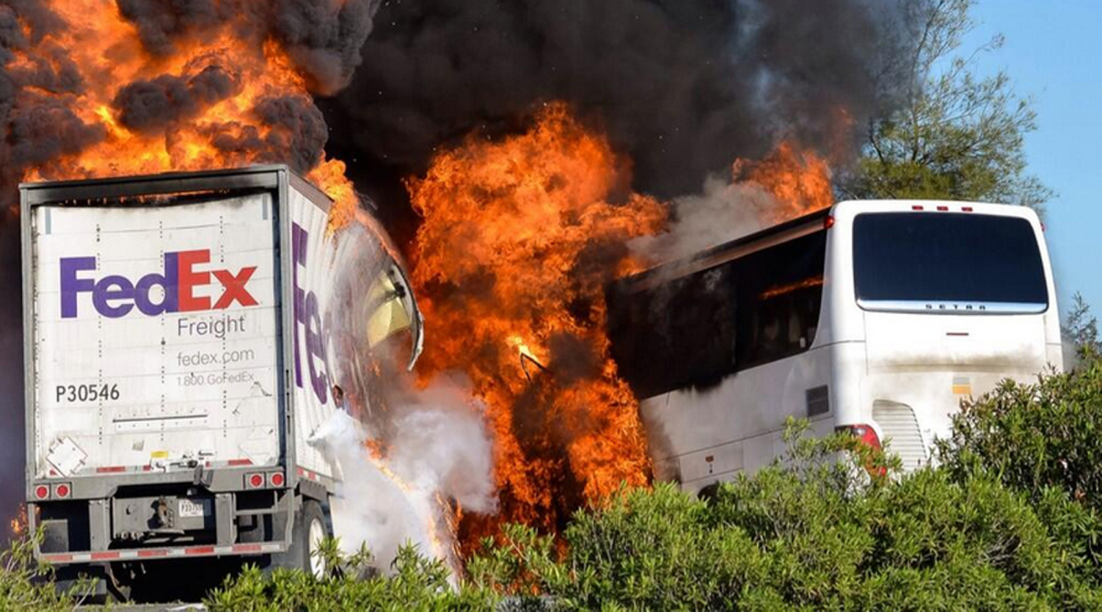 Flames enveloped a tractor-trailer and a tour bus just after the crash Thursday until firefighters were able to extinguish the fire, leaving behind scorched black hulks of metal.