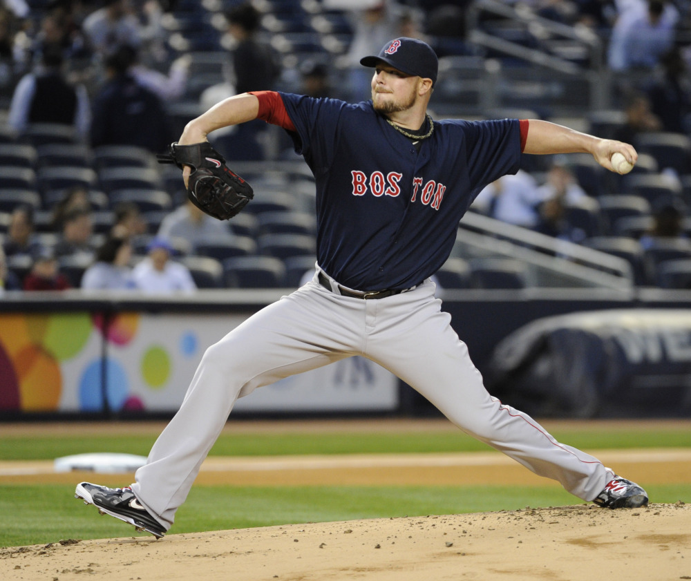 Boston Red Sox pitcher Jon Lester delivers the ball to the New York Yankees during the first inning of a baseball game Friday, April 11, 2014, at Yankee Stadium in New York.