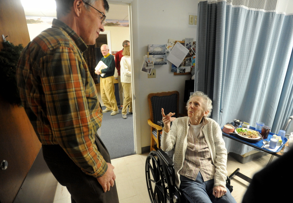Rounds: Kay Squires talks with Harry Vayo of the Tourmaline Singers, as he makes the rounds to visit residents at the Augusta Center for Health and Rehabilitation.