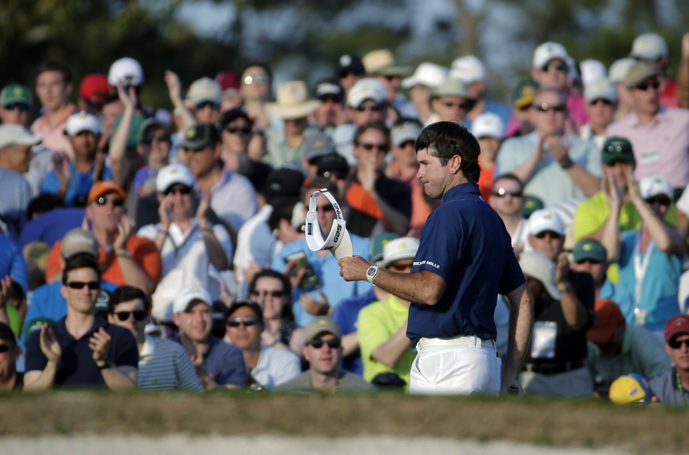 The Associated Press Spectators cheer as Bubba Watson walks up the 18th fairway during the third round of the Masters golf tournament Saturday in Augusta, Ga.