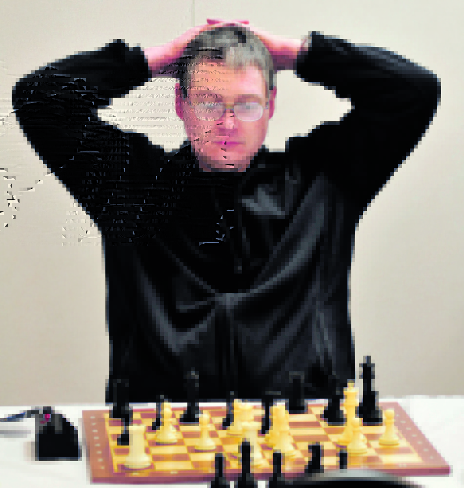 STUDY: Master chess player Jarod Bryan of Augusta studies his next move against player Mathew Fishbein of Cape Elizabeth two hours into the final match of the two-day Maine Closed Chess Championship in Waterville on Sunday.