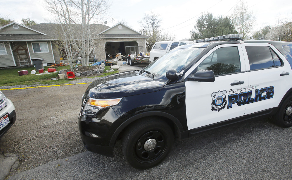 Pleasant Grove Police investigate the scene where seven infants' bodies were discovered Sunday.