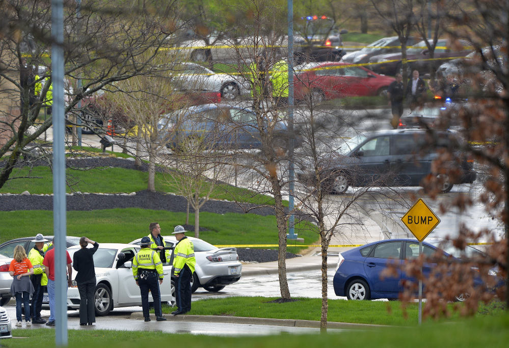 Kansas State troopers stand near the location of a shooting Sunday at the Jewish Community Center in Overland Park, Kan.